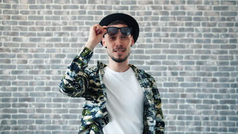 stylish man in camouflage jacket and hat