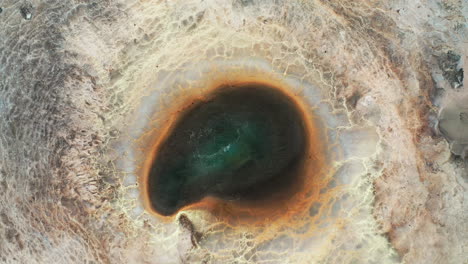 top-down shot of a boiling geothermal spring in icelandic highlands - scenic view in iceland - aerial drone