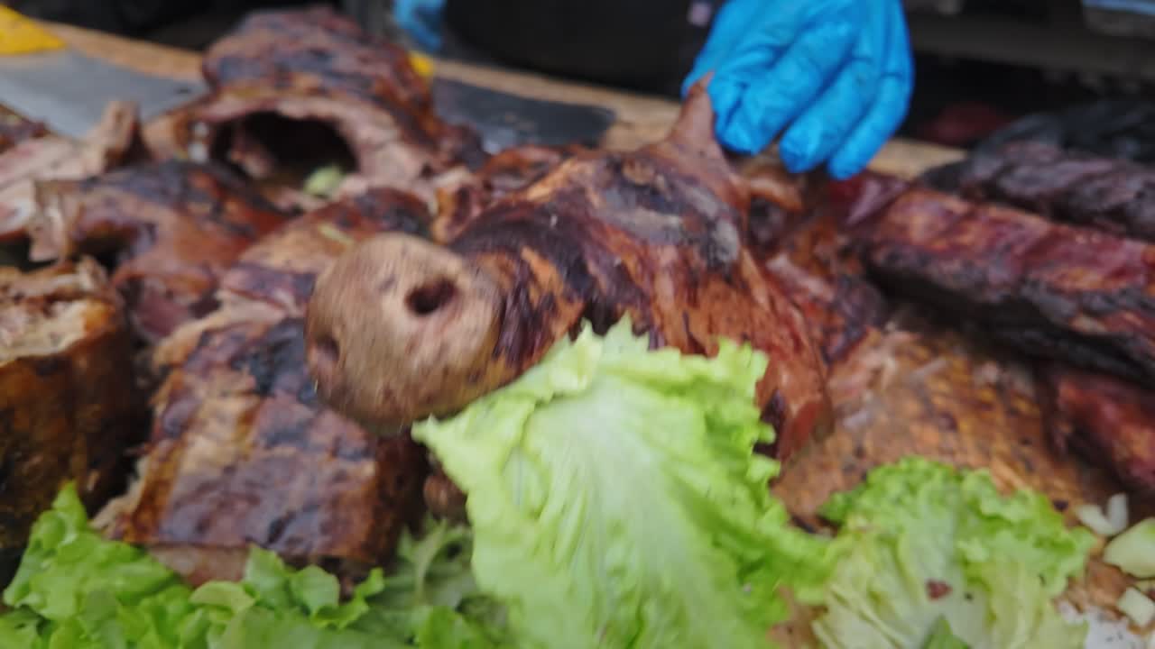 Pigs head displayed with pork meats at festival BBQ food seller stall
