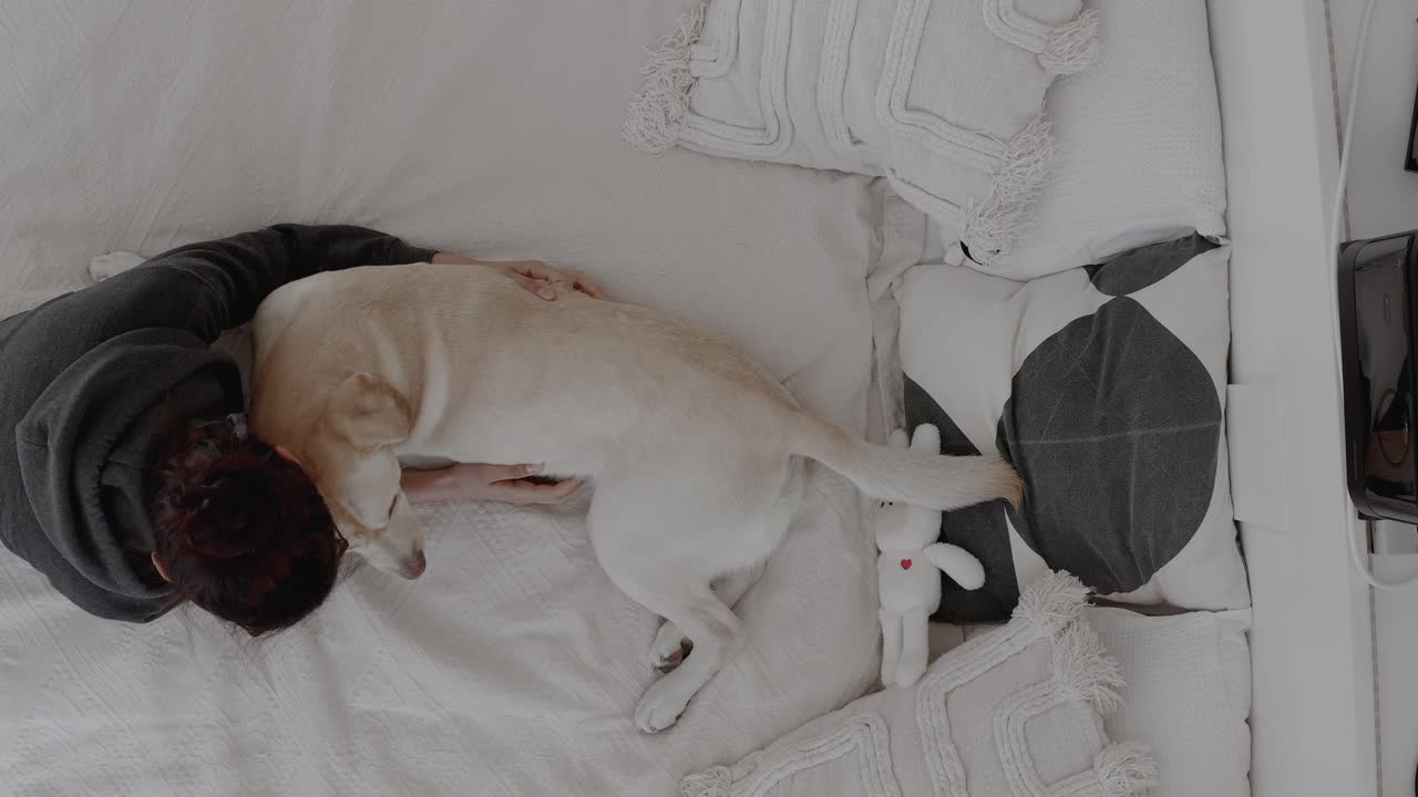 Cuddling with a Labrador puppy, experiencing the joy of living with a dog. Strong human-animal bond. The warmth and affection shared between pet and owner. Emotional support animals and pets.