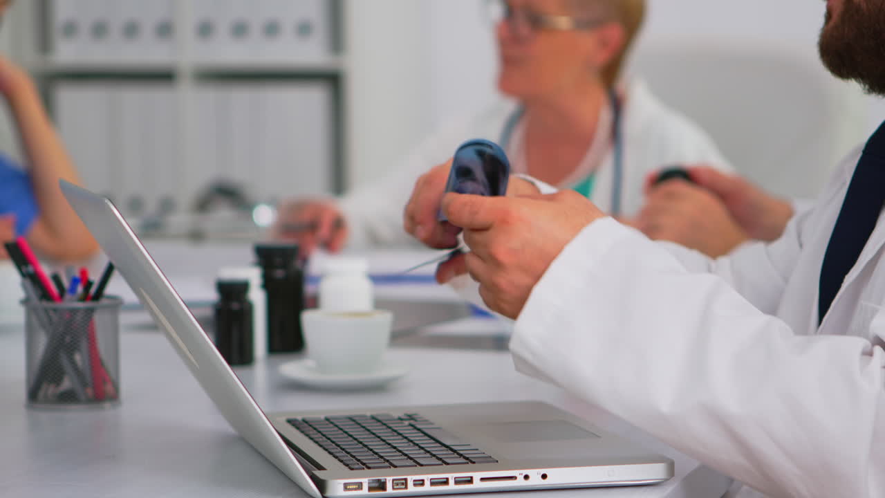 Man doctor using laptop writing treatment informations