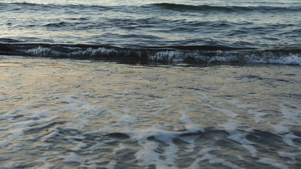 Small waves reach the beach, baltic sea, 4k