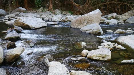 Standbilder-Von-Wasser,-Das-Durch-Felsen-In-Einem-Süßwasserbach-Fließt,-In-Der-Nähe-Von-Cairns,-Queensland,-Australien