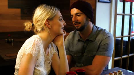 couple interacting with each other in restaurant