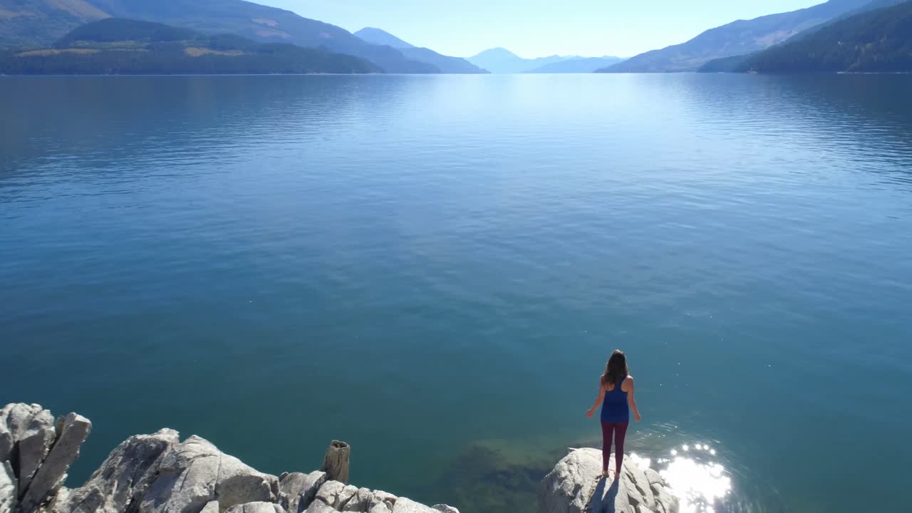 Woman performing yoga on at lake shore 4k