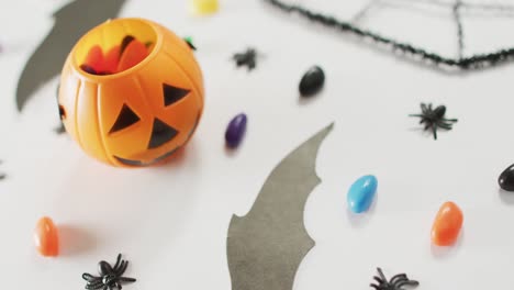 close up of multiple halloween toys and candies on white background