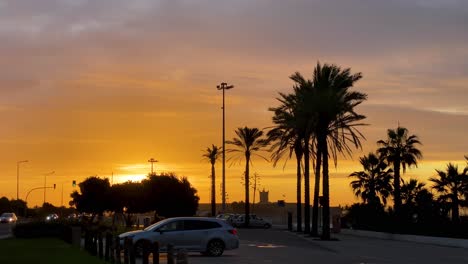 zoom-in-of-city---urban-street-with-cars---sunrise---buildings