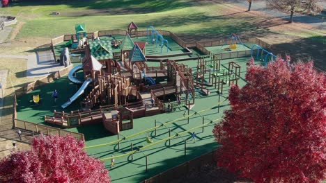 Unrecognizable-children-play-on-playground-at-community-park-in-urban-town-setting