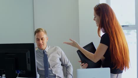 business colleagues discussing over computer 4k