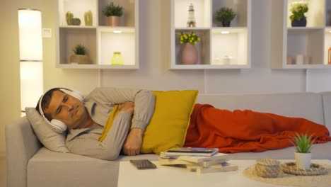Man sleeping listening to music.