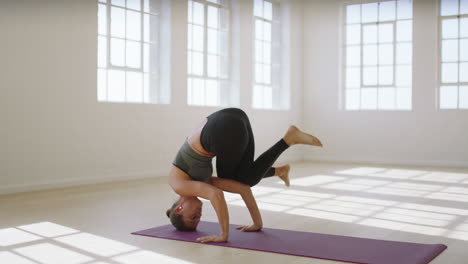 healthy yoga woman practicing flying splits pose enjoying fitness lifestyle exercising in studio stretching beautiful body training on exercise mat