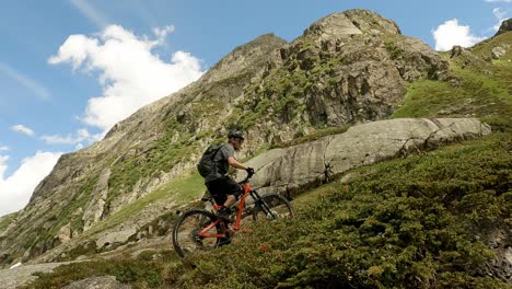 mountain biking with young male mtb athlete on huge rocks i the beautiful alps