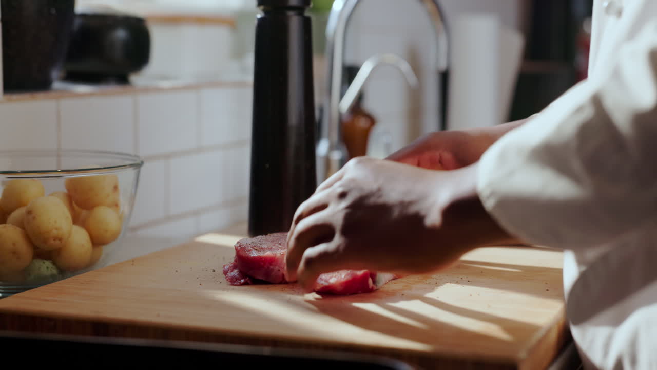 Chef preparing meat in kitchen