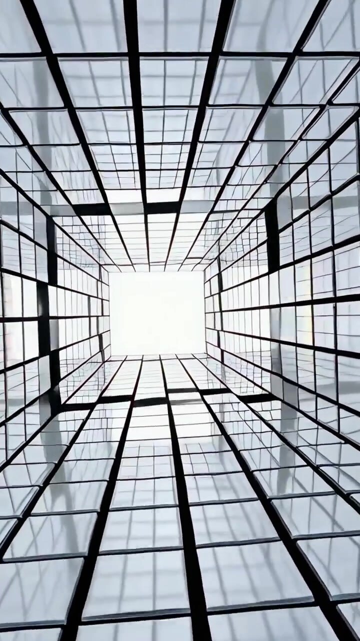 Vertical video: Tilting cam showing lightwell shifting reflections under skylight to frame sky