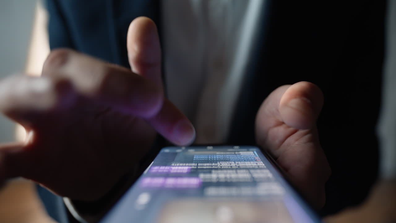 Hands scrolling cellphone screen examining chatbot answer at office closeup