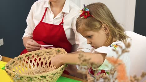 mother and daughter crafting a decorated basket