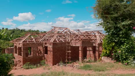 brick house under construction with wooden roof truss on a sunny day