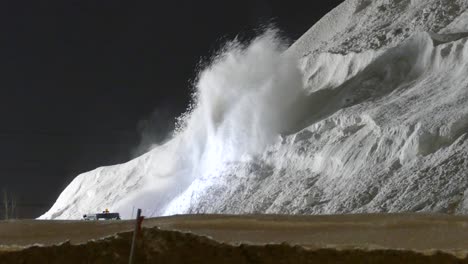 Snow-Blower-Machine-Spraying-Snow-Into-Large-Mountain-At-Night