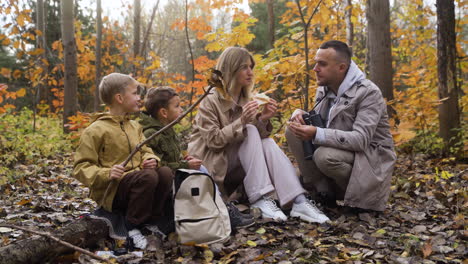 family sitting around a dead tree