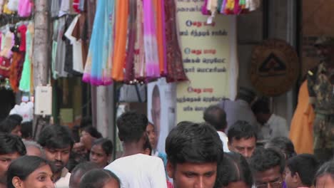 people walking down a very crowded and busy street