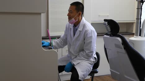 male dentist using desktop pc 4k