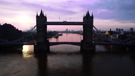 aerial view, silhouette of tower bridge above thames river at dusk over london, england uk