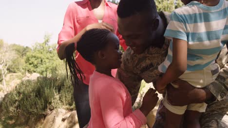 Exited-returning-soldier-man-meeting-his-wife-and-children