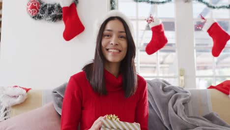Portrait-of-biracial-woman-with-santa-hat-having-video-call