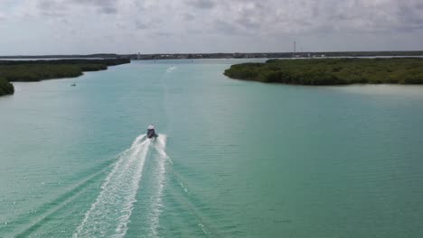 video de vista de pájaro tomado por un dron de un barco que navega en una playa de arena tropical caribeña con agua turquesa - zafiro, laguna de río lagartos, méxico