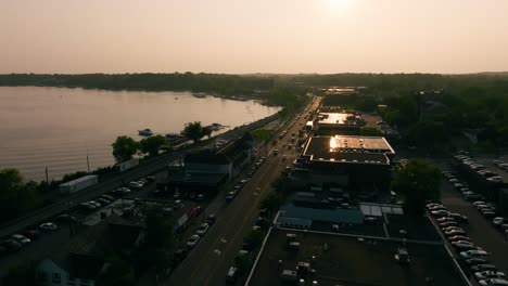 drone shot of a lakeside town during sunset