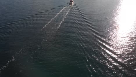 Drone-Aerial-footage-of-a-boat-in-the-Lofoten-Islands,-Norway-during-winter