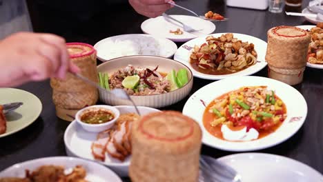 people sharing a traditional thai meal together