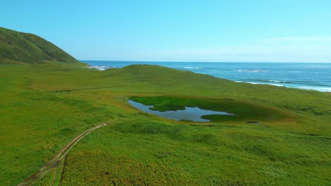 coastal landscape with pond and ocean view