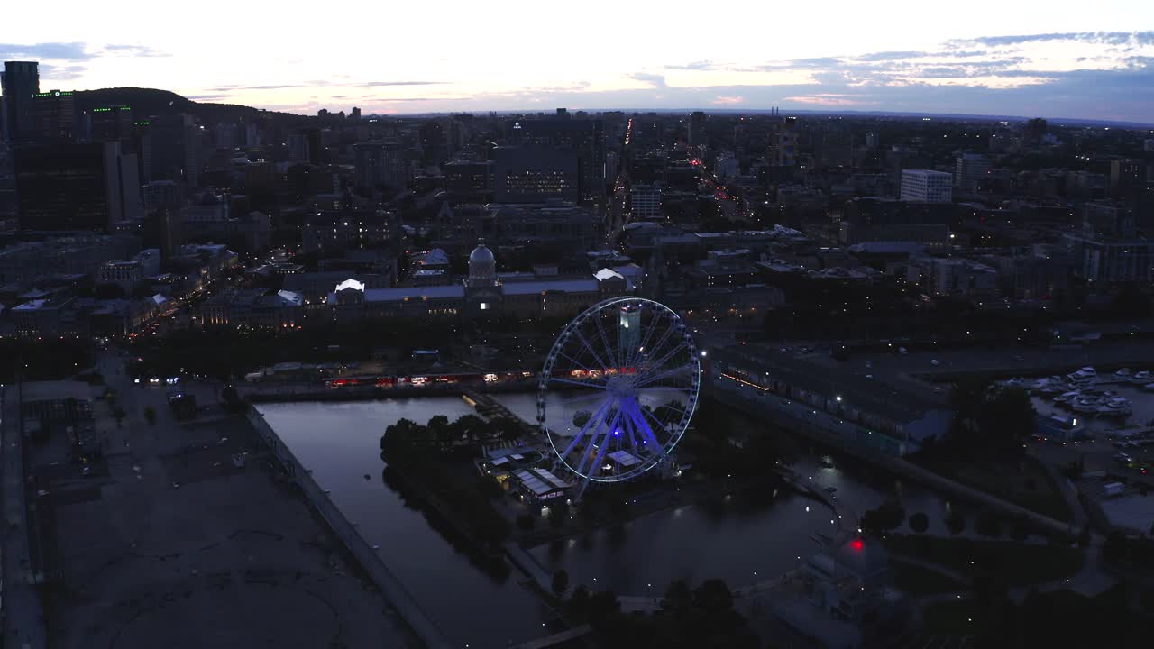 Aerial shot of Montreal's Old Port with the Ferris wheel in view, showcasing the vibrant waterfront and historic architecture. Perfect for capturing the essence of the city.