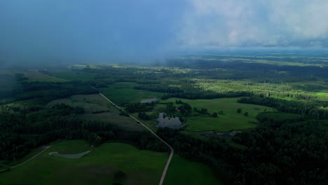 Clouds-Engulfing-Verdant-Rural-Landscape-During-Sunrise