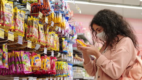 woman shopping for candy in a grocery store