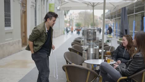 street magician entertaining cafe patrons