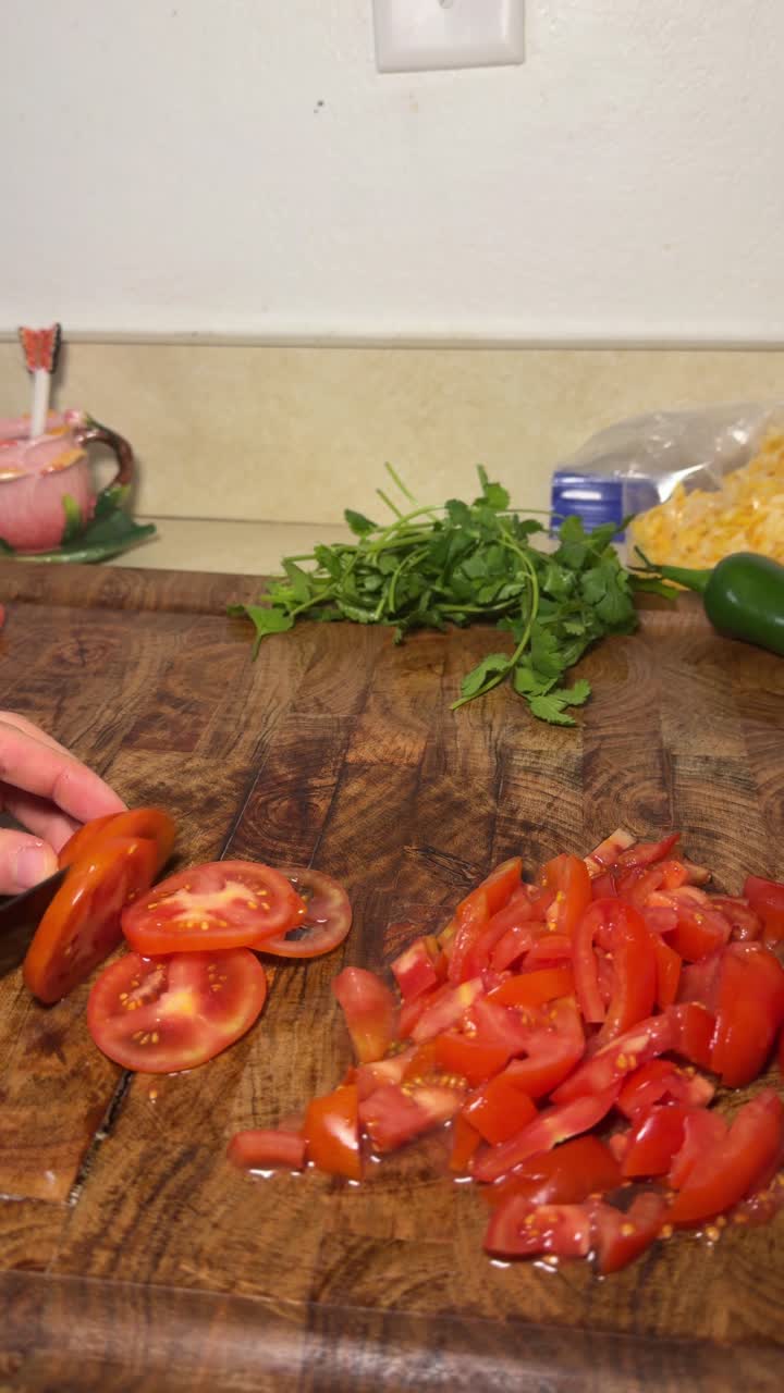 close up shot chopping tomatoes nice and small