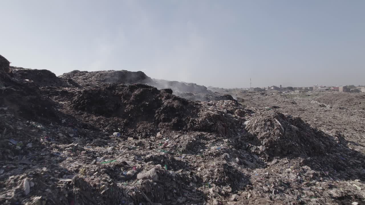 Aerial drone shot reveal shot of Dandora dumpsite in Nairobi Kenya showing garbage piles deposited