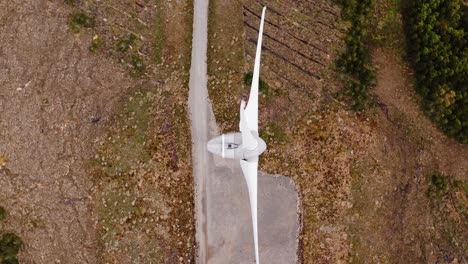 birds eye view drone shot of a wind turbine in operation on the hebrides