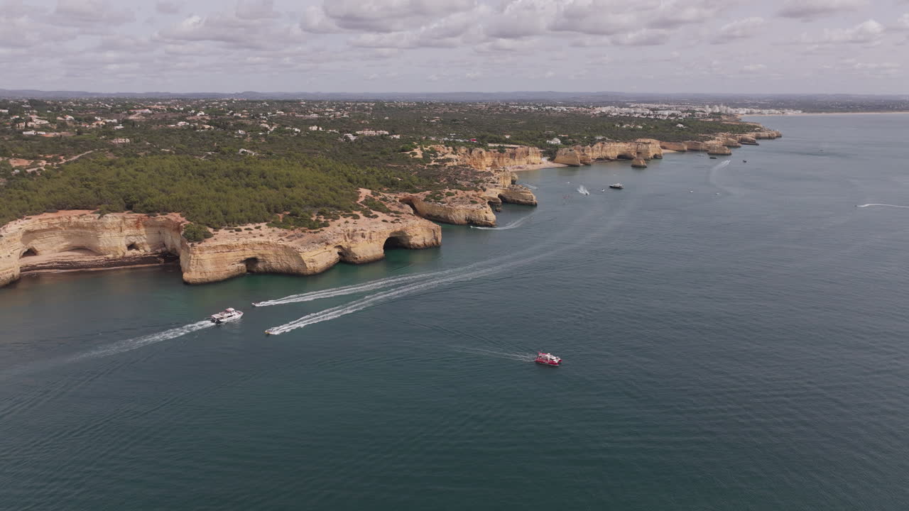 Aerial drone view of the Benagil Sea Caves and Atlantic Ocean coastline in Benagil, Algarve, Portugal, Europe
