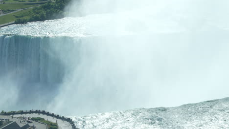 A-close-up-shot-of-water-and-mist-over-the-edge-of-Horseshoe-Falls-in-Niagara-Falls,-Ontario