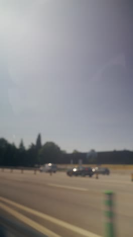 Blurry Roadside Views with Sun Flares from a Moving Vehicle