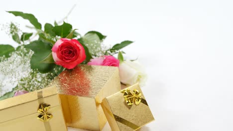 golden gift boxes and bouquet of roses 4k