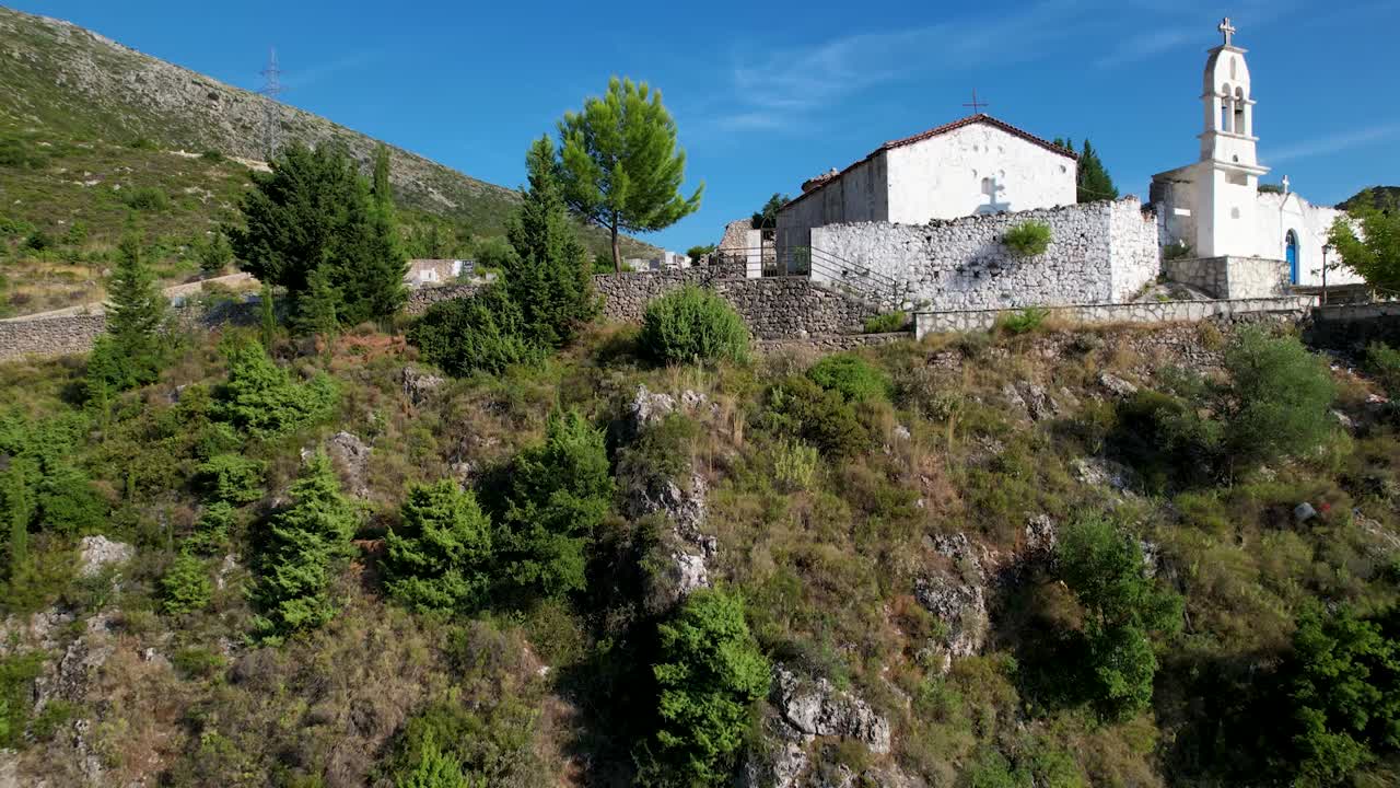 Hilltop Church Overlooking the Green Hills of Dhermi, Albania's Stunning Riviera Landscape