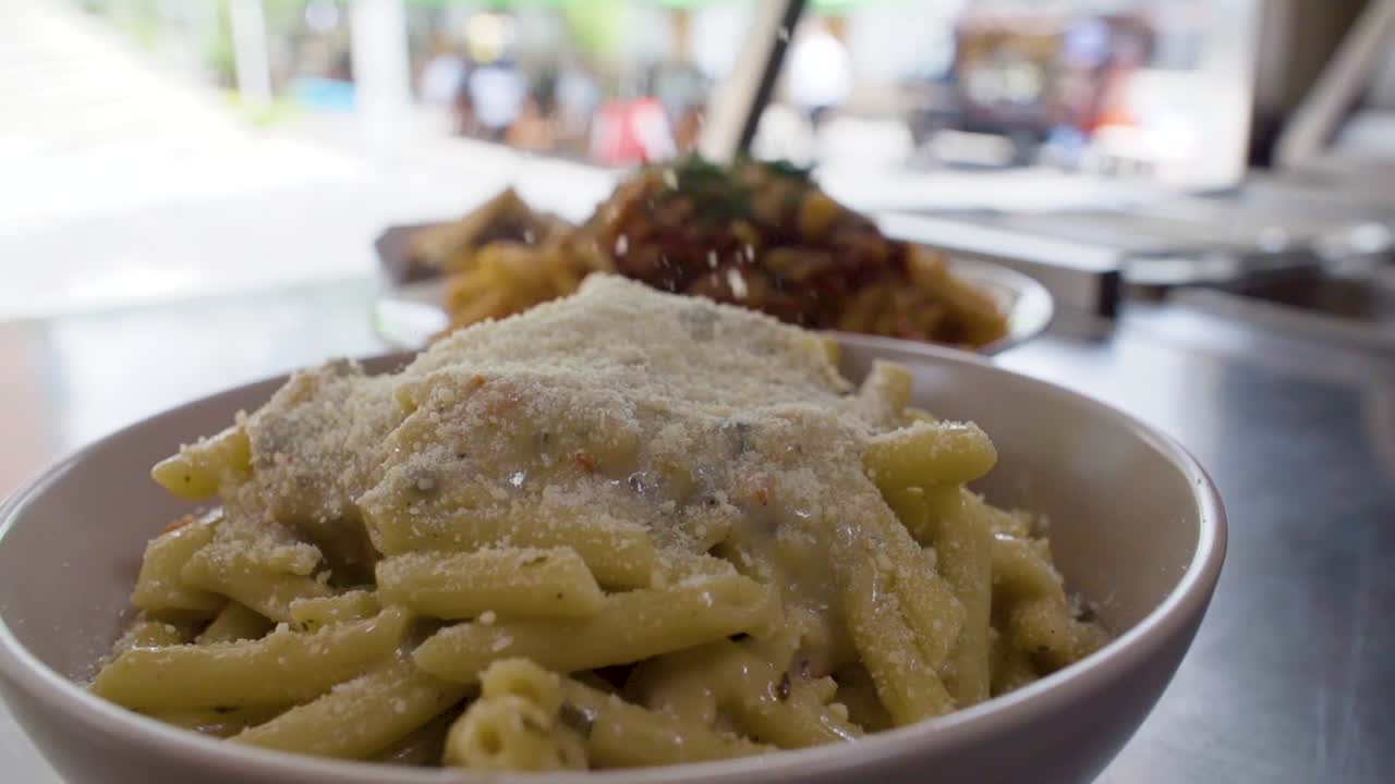 Serving  delicious cheese in the noodles with salsa slowly