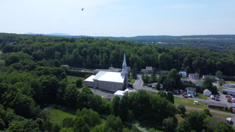 aerial view of a church in a forested rural landscape