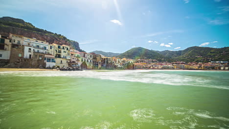 Static-shot-of-the-town-of-CefalÃ¹,-Palermo,-Sicily-with-the-view-of-hilly-terrain-along-the-Tyrrhenian-Sea-in-timelapse-on-a-bright-sunny-day