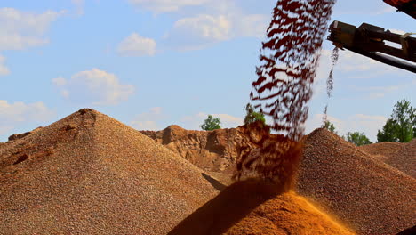 Conveyer-dumping-graded-gravel-in-a-pile-at-a-stone-quarry---slow-motion