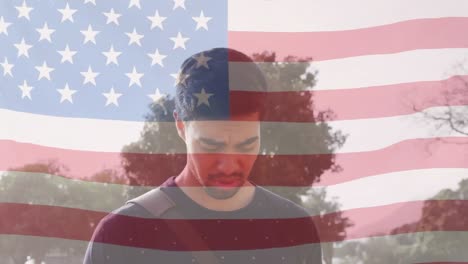 Animation-of-flag-of-usa-over-biracial-man-using-smartphone